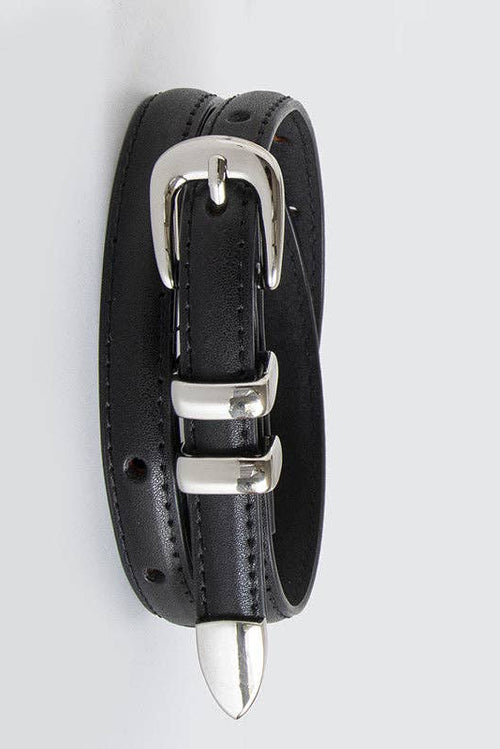 Black leather collar with silver buckles and spike on a light gray background