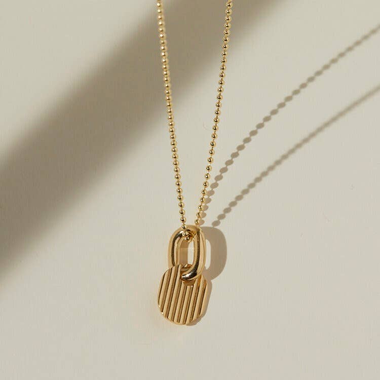 Gold ring and charm necklace