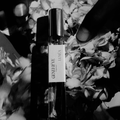 Perfume bottle labeled 'LUNEA' with flowers in the background
