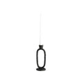 Black candle holder with a white candle on a white background