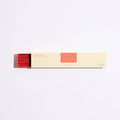 Box of incense sticks with red and beige design on a white background