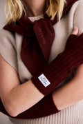 Person wearing a brown scarf and gloves with 'Arctic Fox' branding.