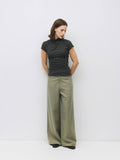 Woman wearing grey slouchy top and wide leg pant.