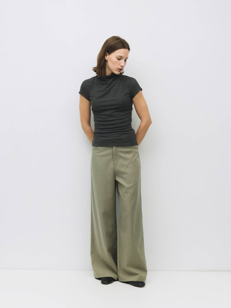 Woman wearing grey slouchy top and wide leg pant.