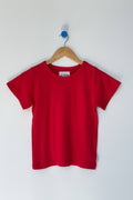 Red t-shirt on a wooden hanger against a white background