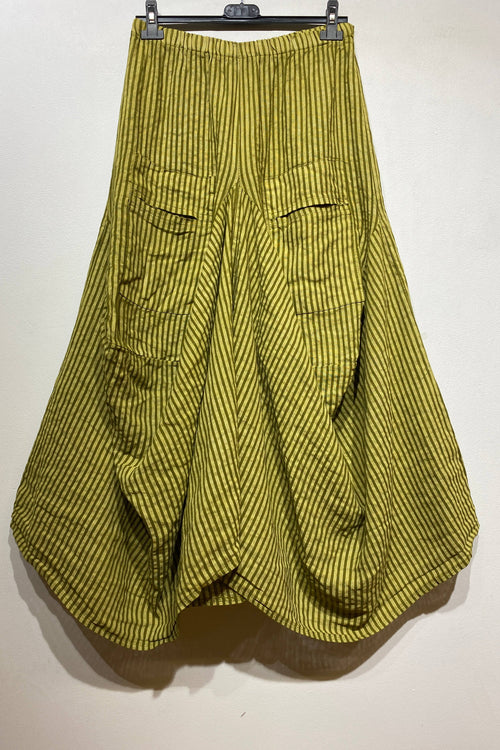 Green striped pants hanging on a rack against a white background