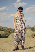 model wearing brown and white zebra dress standing in desert background