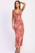 Woman wearing a patterned dress on a white background