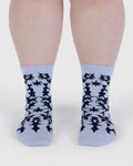 Light blue socks with black abstract pattern worn by a person on a white background