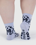 Light blue socks with black paw prints and 'BAGGU' branding worn by a person on a white background