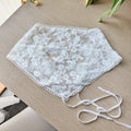 White lace headband on a wooden surface