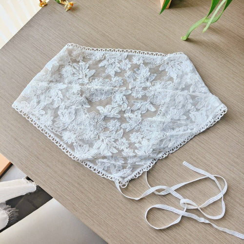 White lace headband on a wooden surface