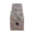 Marble-textured square block with a cylindrical hole on a white background