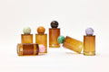 Set of glass containers with colorful spherical lids on a white background