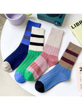 Colorful socks with striped patterns on a white surface