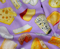 Pattern of various types of cheese on a purple background
