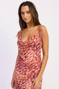 Woman wearing a patterned dress on a white background