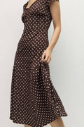 Brown polka dot dress on a plain background