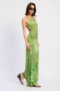 Woman wearing a green dress with cut-out design on a white background