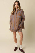Woman wearing a striped shirt and shorts set on a beige background