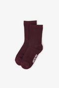 Pair of maroon socks with a brand logo on a white background