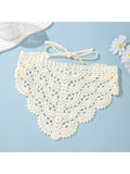White crocheted collar with a bow on a light blue background
