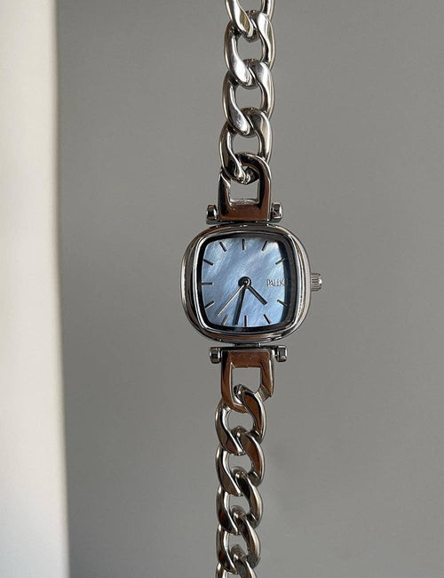 Wristwatch with a chain strap on a gray background