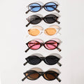 Set of six cat-eye sunglasses with different colored lenses on a white background