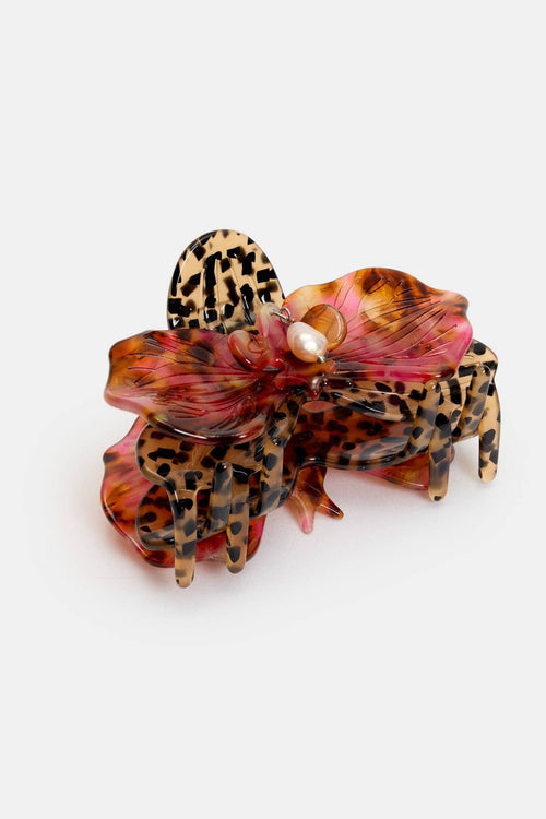 Leopard print hair clip with pink accents on a white background