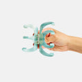 Hand holding a turquoise dental tool against a white background