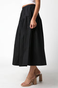 Person wearing a black skirt on a white background