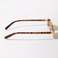 Sunglasses with tortoiseshell frame and gold accents on a white background