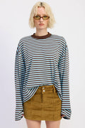 Person wearing a striped long-sleeve shirt and corduroy skirt on a white background