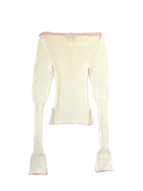 Cream-colored ribbed knit top with pink trim on a white background