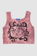 A pink tie-dye sleeveless crop top with a black floral and scroll graphic on the front, displayed flat against a light gray background.